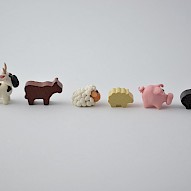 Handmade meeples next to original Agricola markers