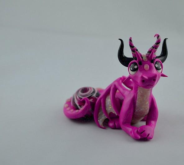 pink dragon with a gem